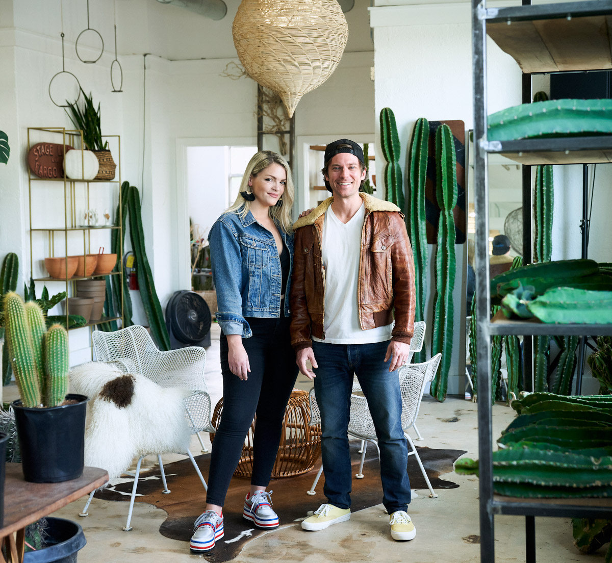Shelby and Will Perry standing among dozens of cacti