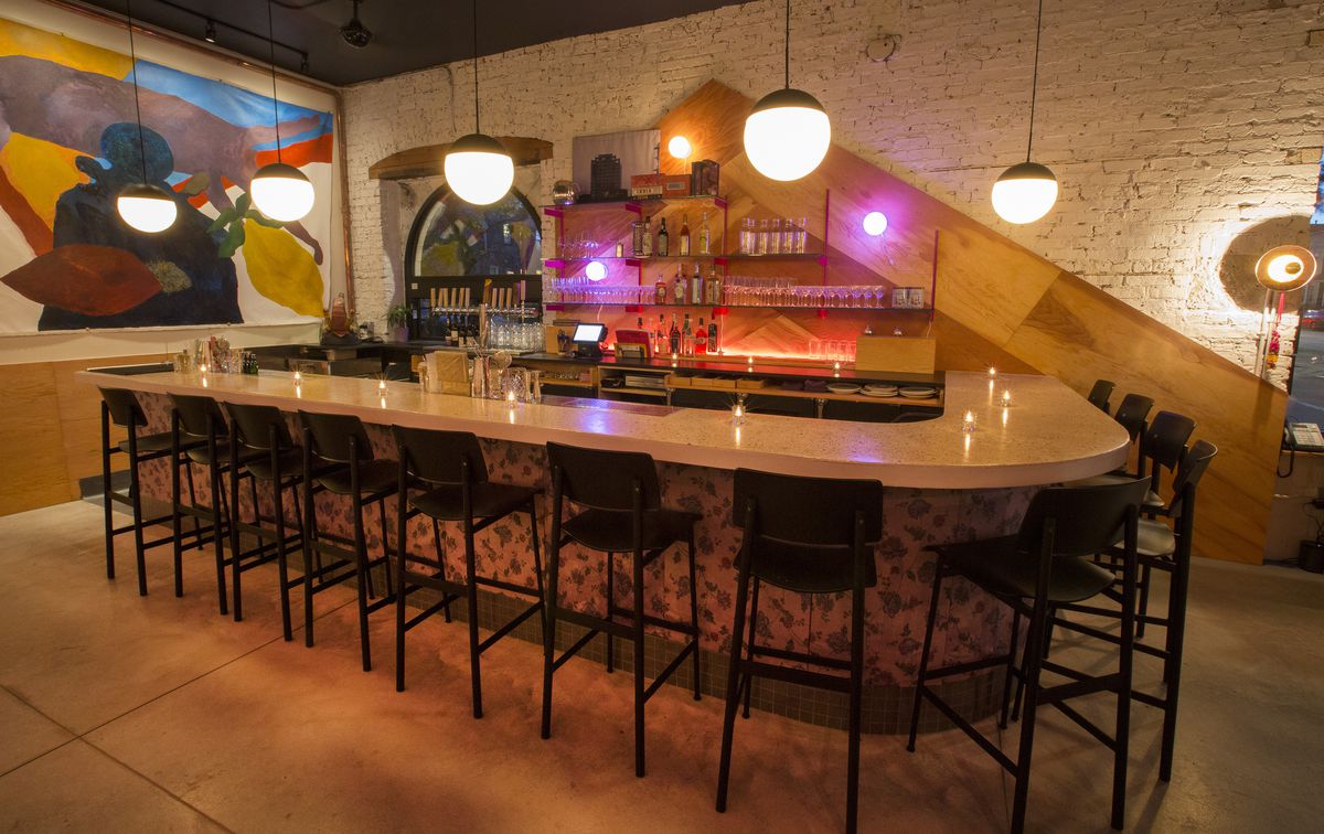 A large geometric wooden bar with purple lights.