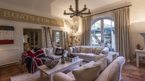 Colonial feel: Much of the decoration was inspired by a visit to Hemingway’s home and the kitchen, below, is John’s famous Crème de la Crème, sold all over the world
