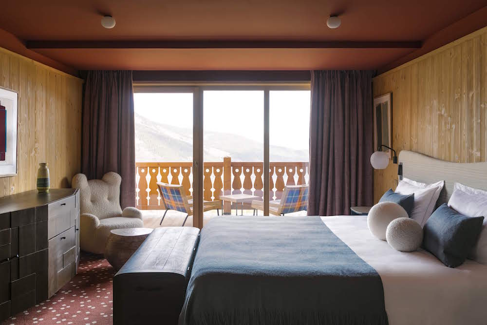 Bed and balcony door overlooking the piste