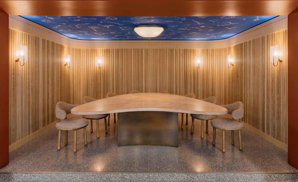 blue ceiling with odd shaped table under